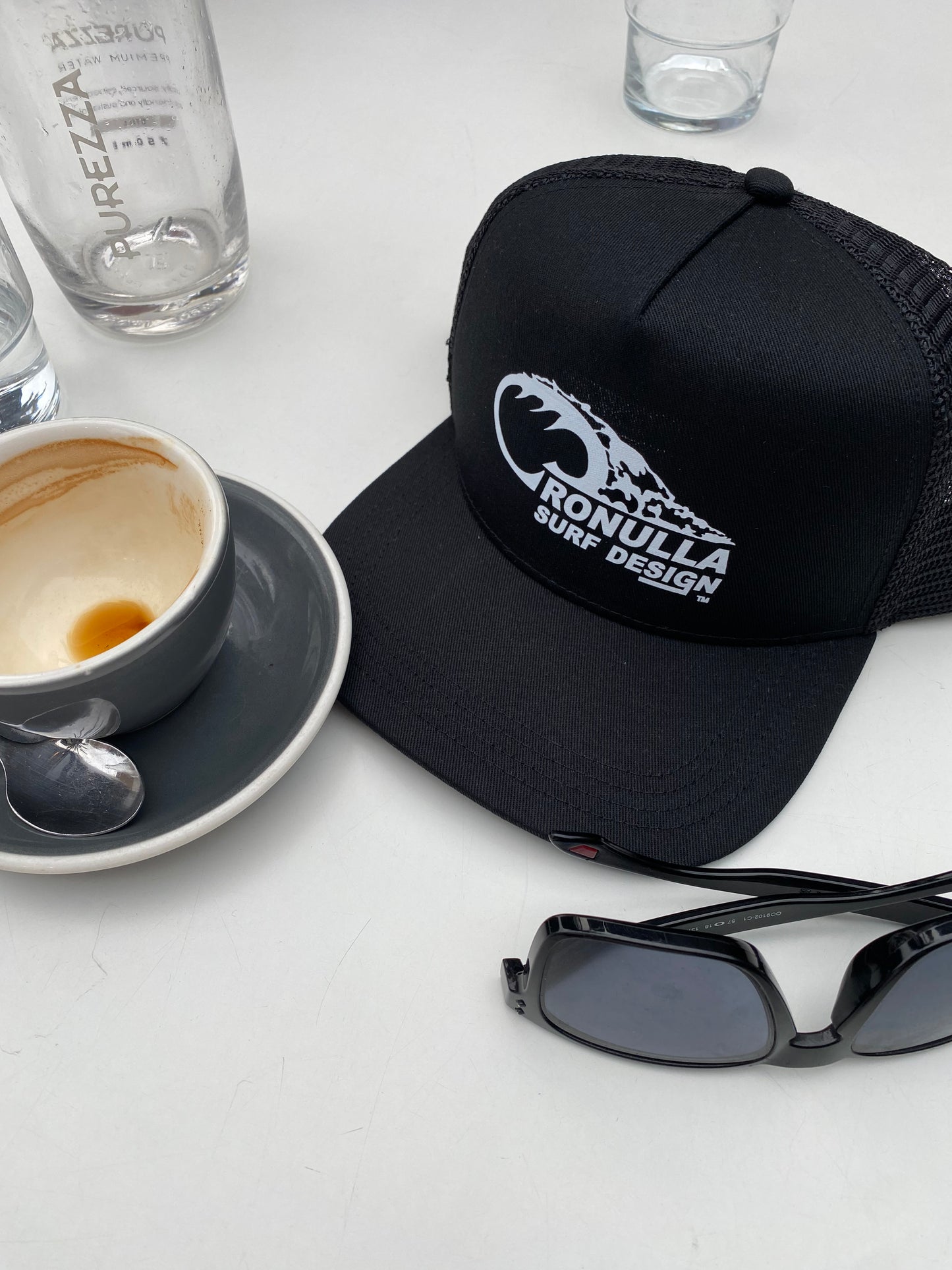 Cronulla Surf Design lifestyle with trucker cap and coffee